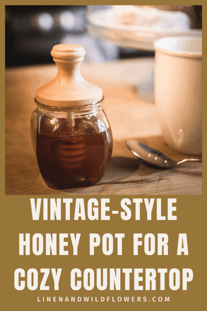 Pinterest pin titled Vintage-Style Honey Pot for a Cozy Countertop, showing a close-up of the honey jar with wooden lid on a wood counter.