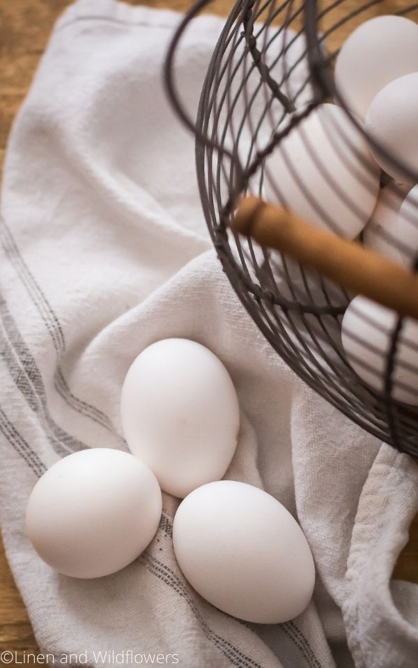 16 Useful Kitchen Tips-basket of eggs on a tea towel next to three eggs,