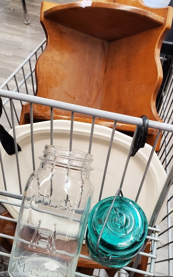 Cart Shot at the thrift store of a 3 teir corner shelf, atlas mason jar, blye ball mason jar, & a white platter