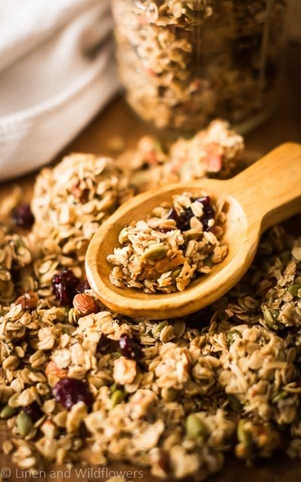A wooden scoop with homemade granola for 5 quick & easy snack recipes