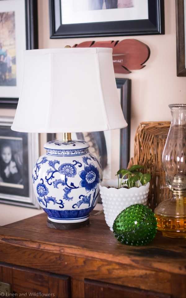 A blue & white vintage style lamp with  a white lamp shade, green fenton half bowl, milk glass potho planter, oil lamp & a basket is what I  Thrift for Home Decor