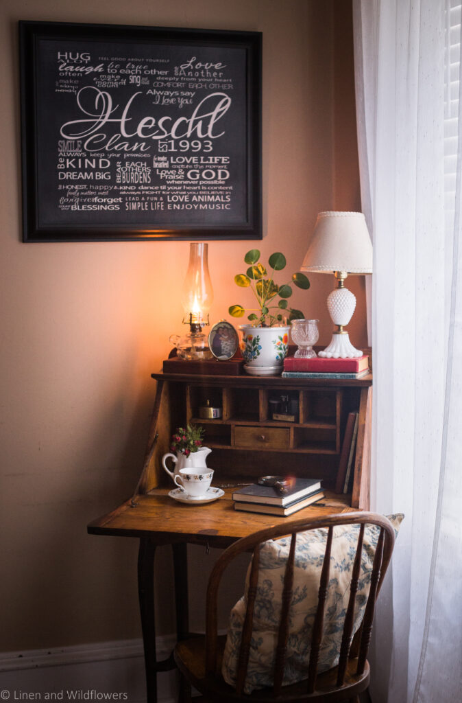 How to Thrift for Home Decor is just what I need to decorate this beautiful small secretary desk with vintage finds, such as an oil lamp, teacup & saucer, magnifying glass,  2 old small books, photograph stamp, milk glass lamp, with a little brass photo of a gal with her grandmother.