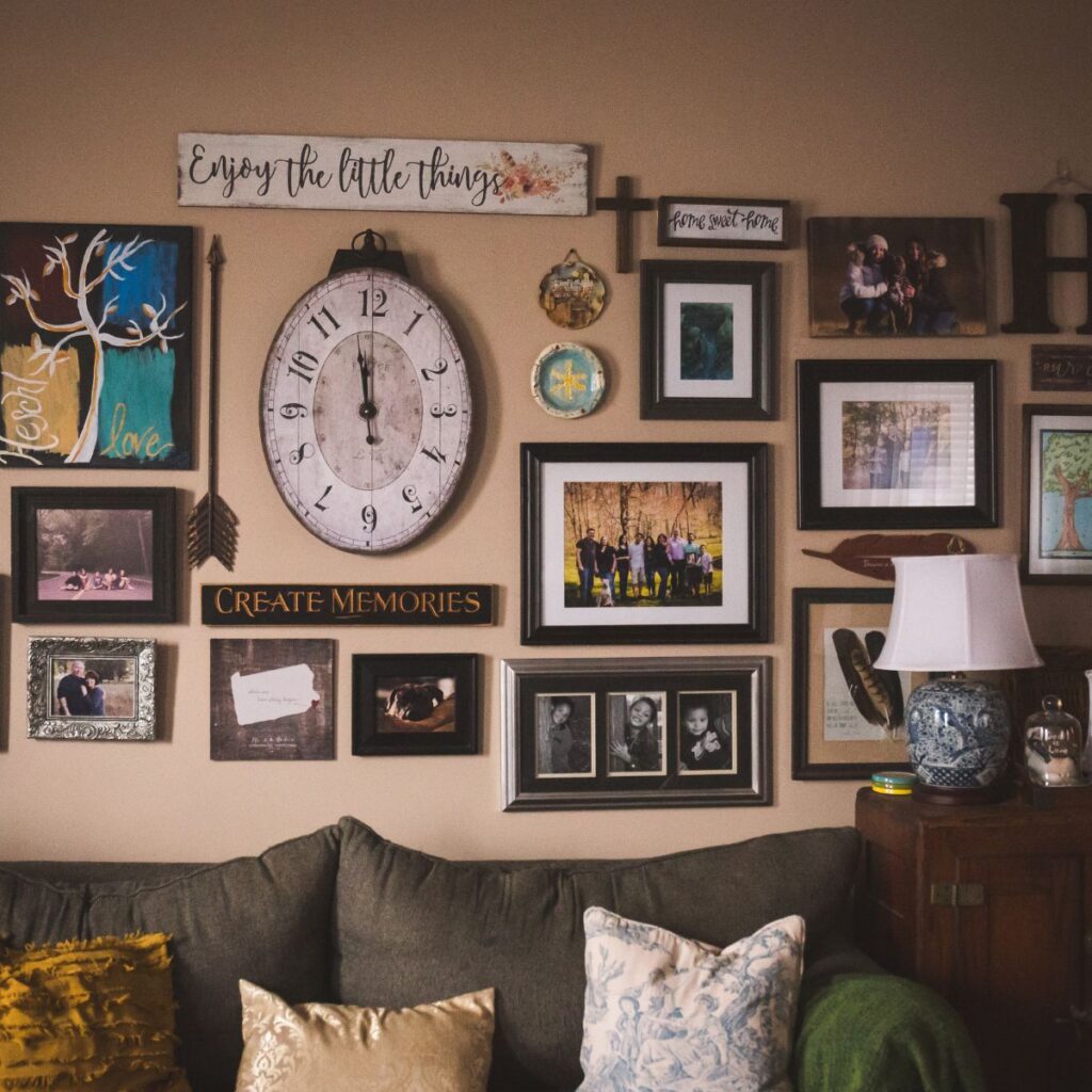 40 Wall Ideas for Your Home-LinenandWildflowers.com-A wall gallery of family photos & memborbilia on the wall above the couch,