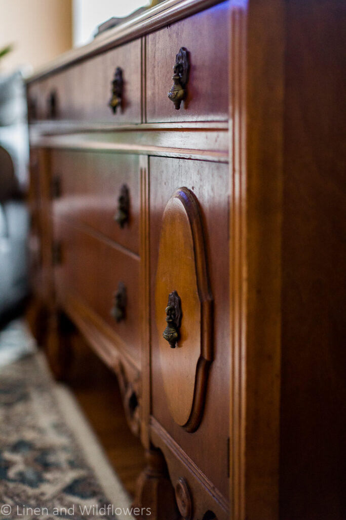 Sideboardwith carved details on the fron cabinets & patinaed brass hardware.