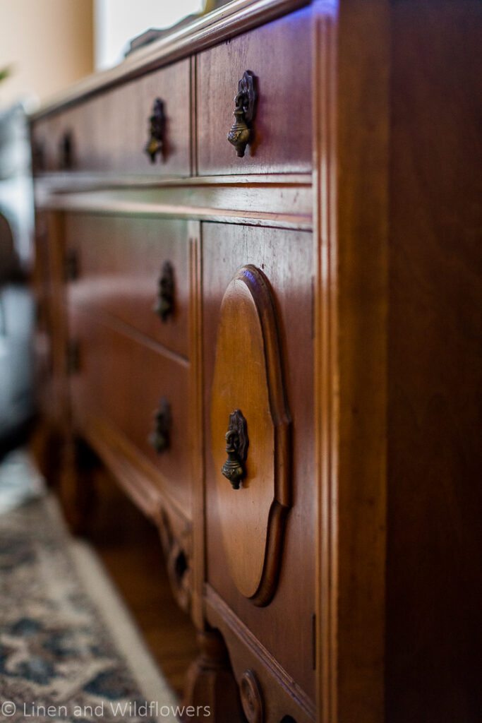 Sideboardwith carved details on the fron cabinets & patinaed brass hardware.