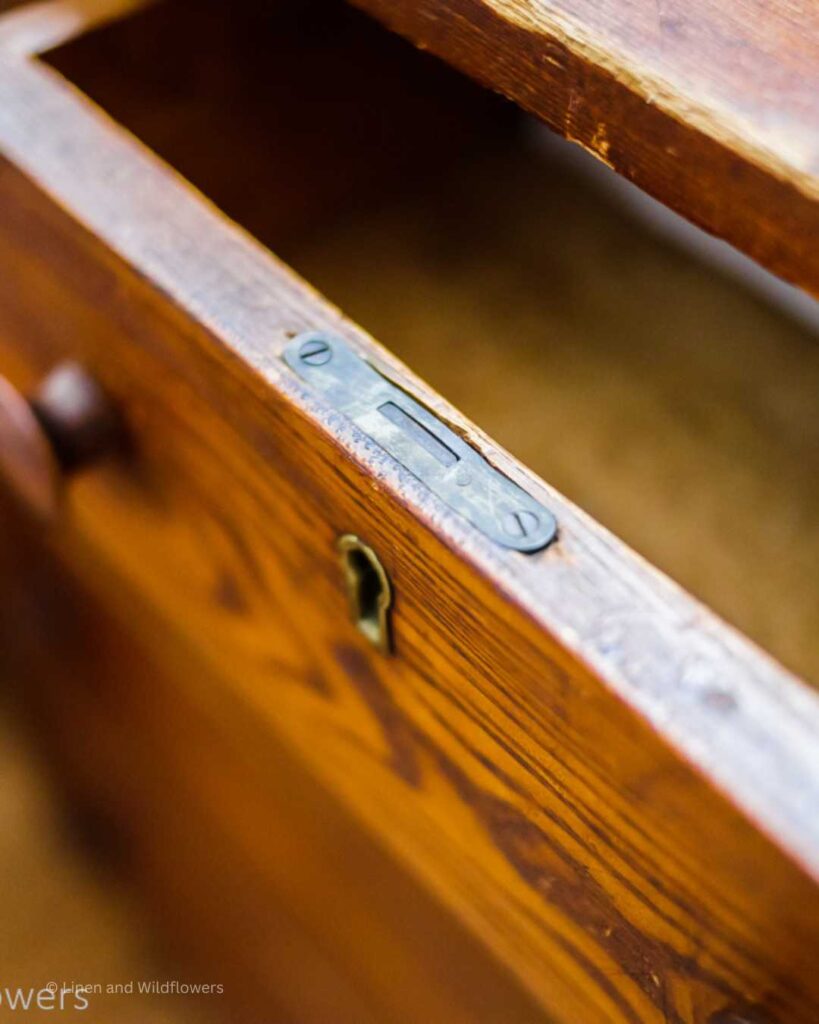an antique dresser with details of an olk skeleton key hole lock.