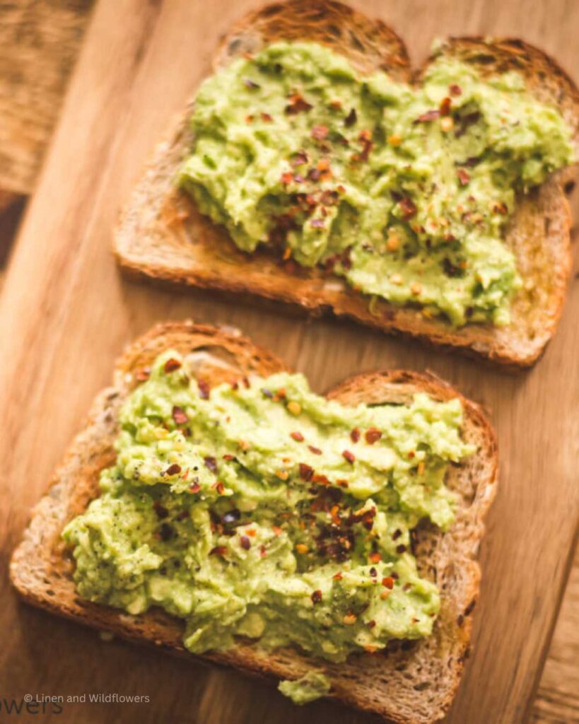 Slices of toasted bread with avocado spread on top.