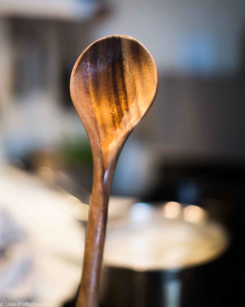 Close-up of a freshly oiled wooden spoon, a quick hack for conditioning and extending the life of wooden utensils.