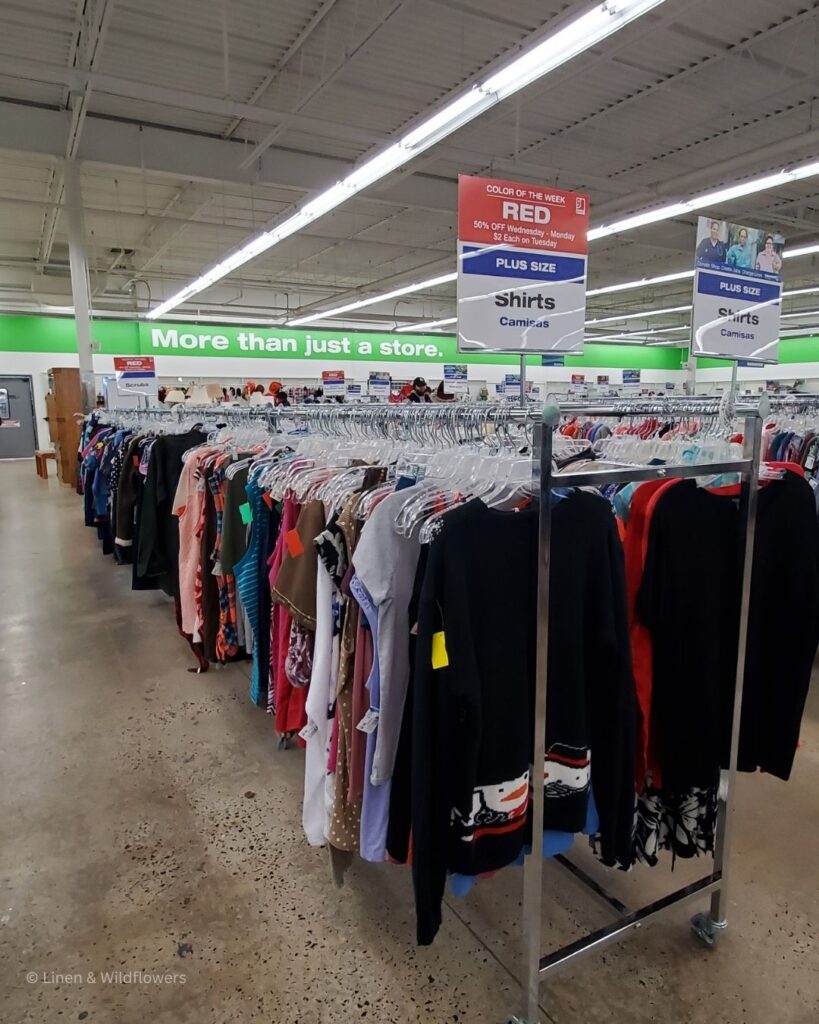 Racks of used clothes for sale in a thrift store.