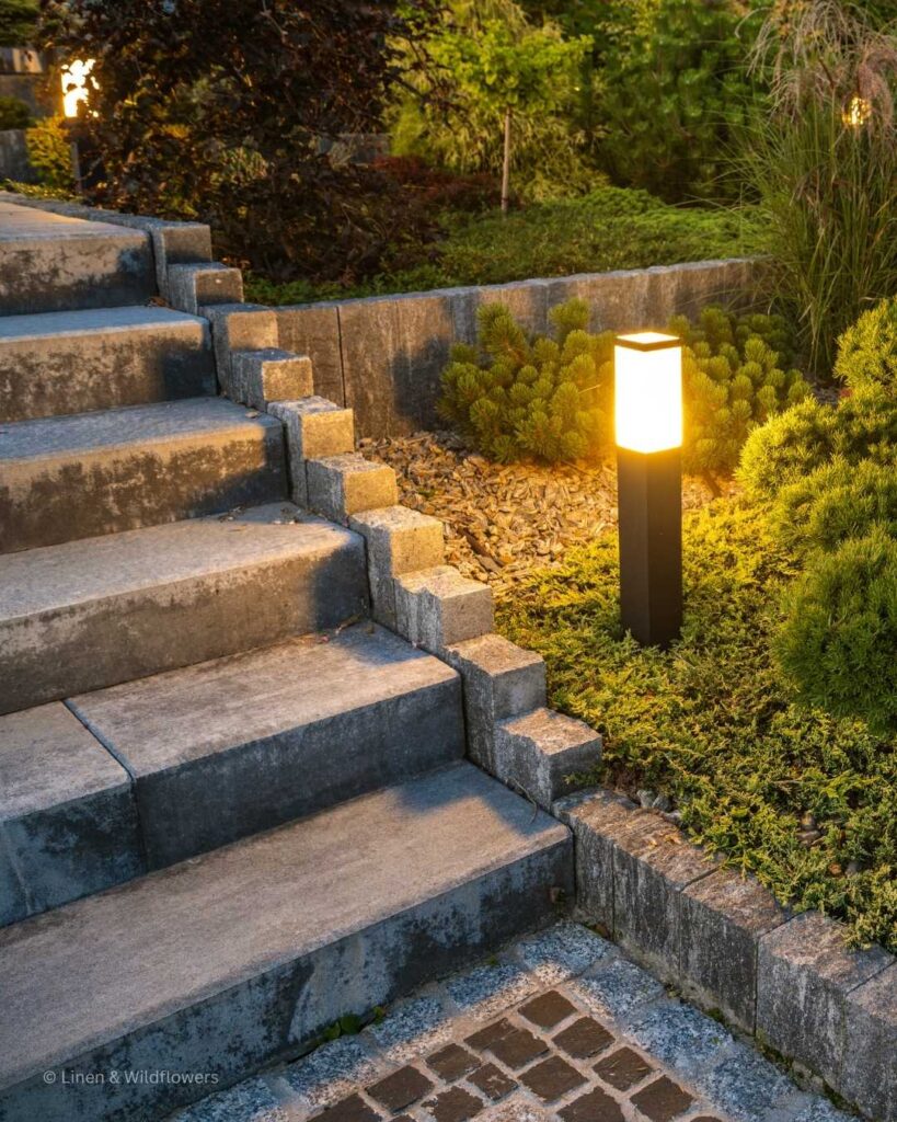 A pathway of steps illuminated with a  solar light fixture.