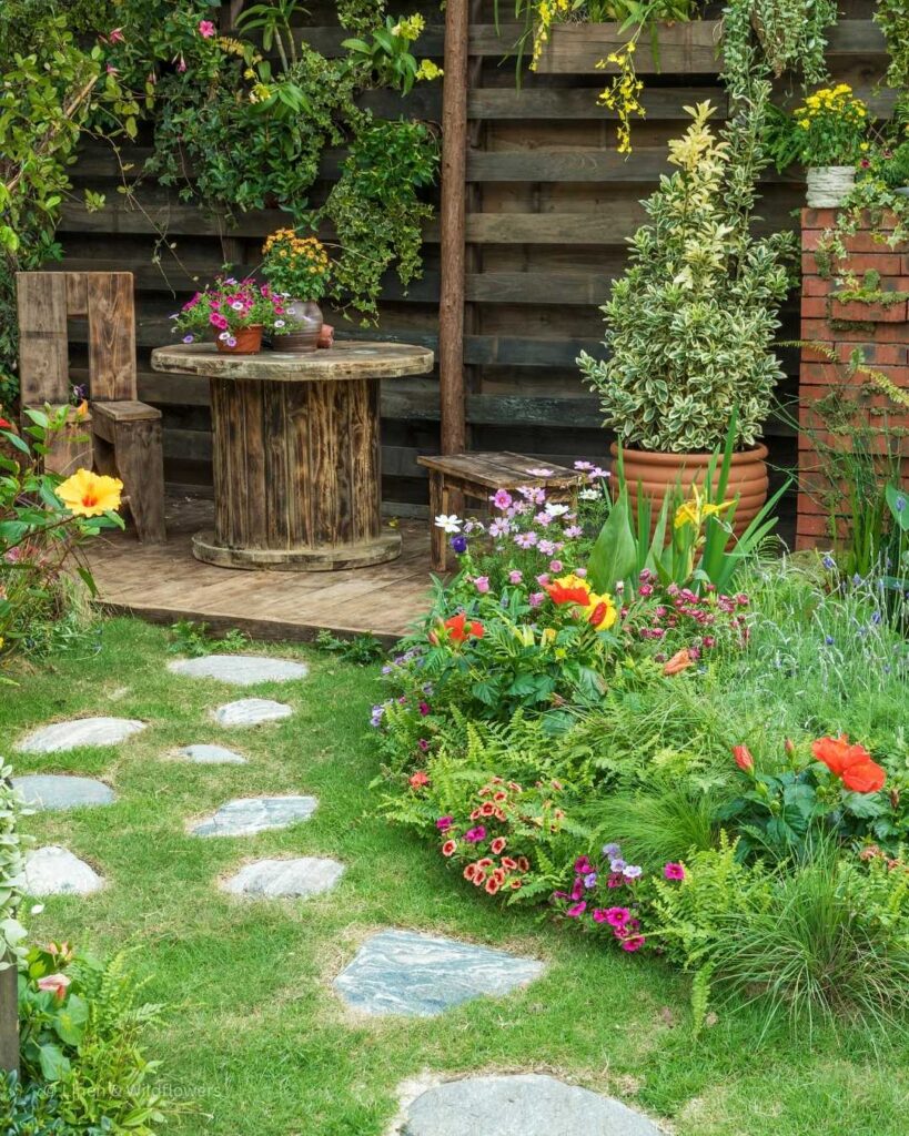  A beautiful & colorful garden with a handmade table, chair & bench. 