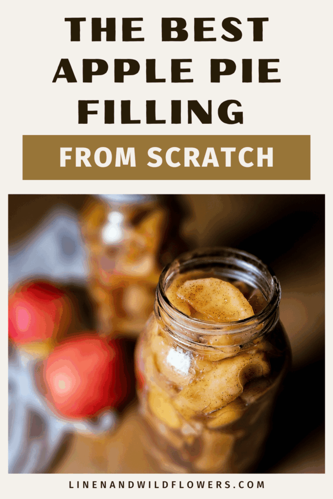 A jar filled with homemade apple pie filling beside red apples on a cloth. Text above reads "The Best Apple Pie Filling From Scratch." Cozy, inviting tone.