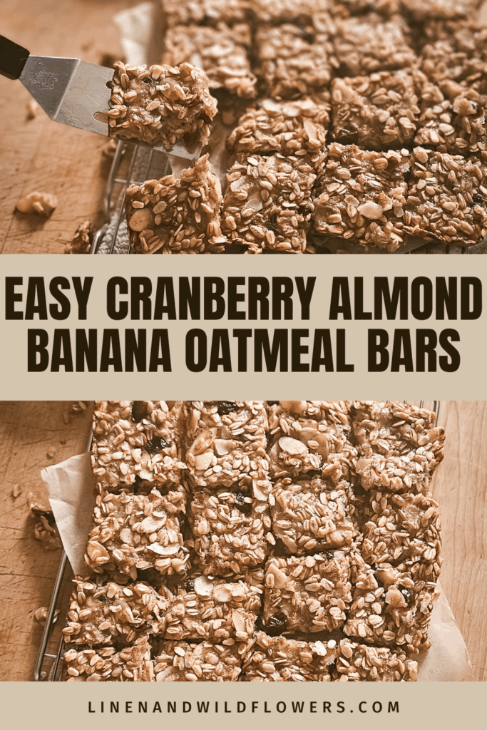 A knife lifts a square of cranberry almond banana oatmeal bars from a batch on a wooden surface. The bars are golden brown and textured.
