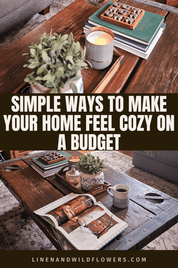 Cozy living room with a rustic wooden coffee table featuring books, a candle, a plant, and a decorative game. Text reads "Simple Ways to Make Your Home Feel Cozy on a Budget."
