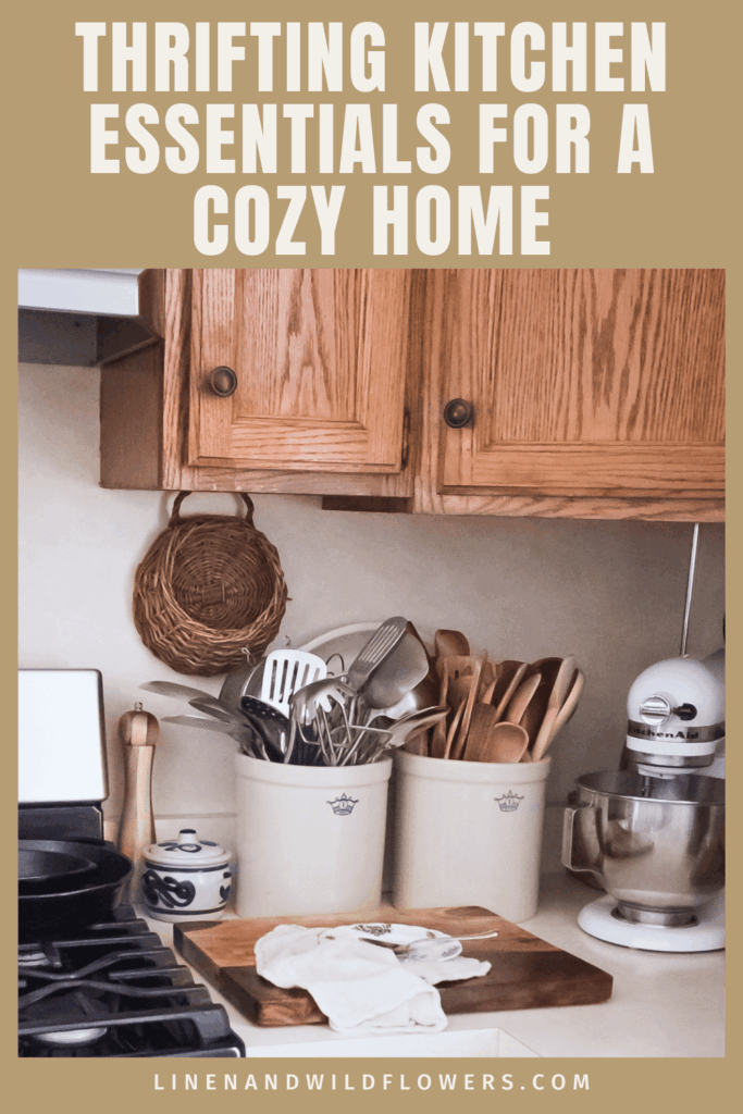 Cozy kitchen corner with wooden cabinets, vintage utensils in jars, a cutting board with cloth, mixer, and stove. Text: "Thrifting Kitchen Essentials."