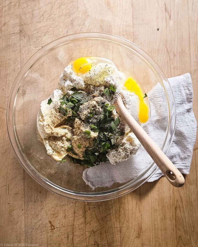 Ricotta cheese mixed with egg, parsley, and seasoning for lasagna filling.