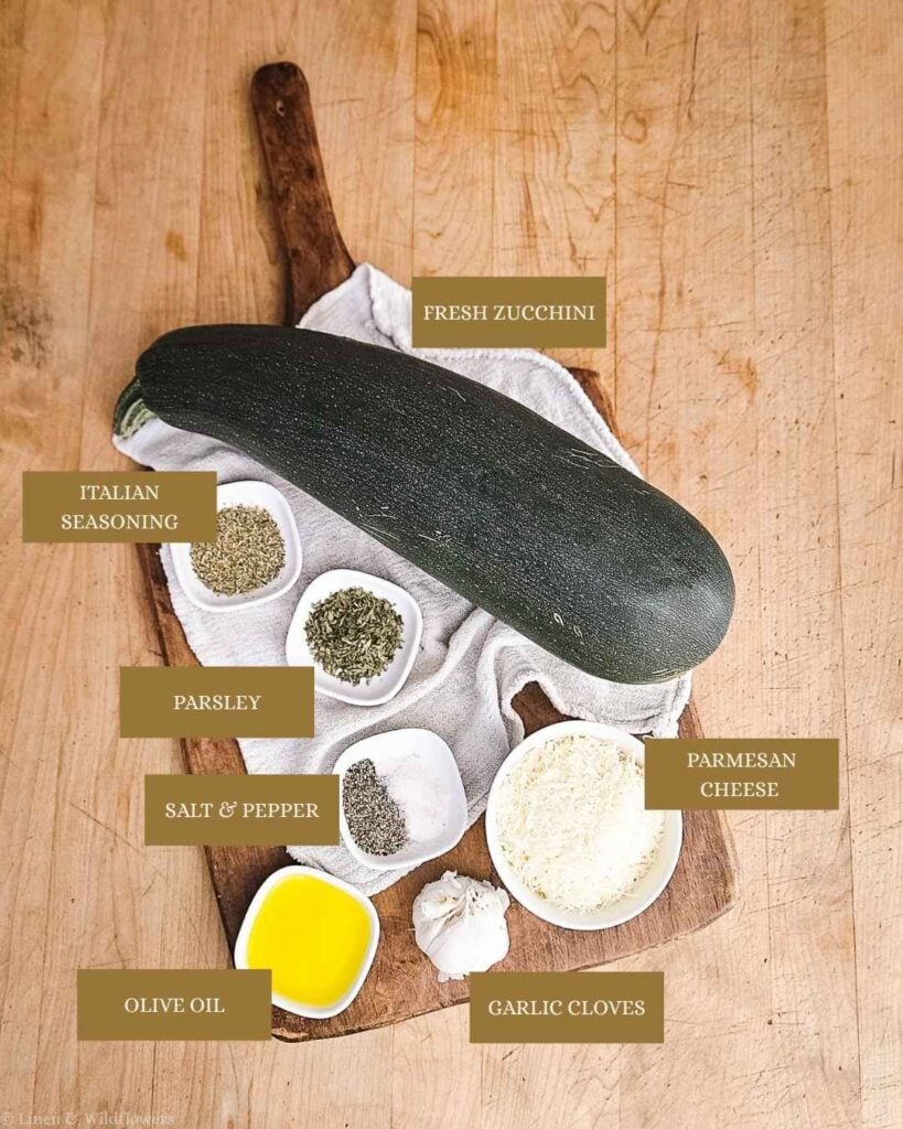 Labeled ingredients for garlic Parmesan zucchini — zucchini, Italian seasoning, parsley, salt and pepper, Parmesan cheese, olive oil, and garlic cloves.