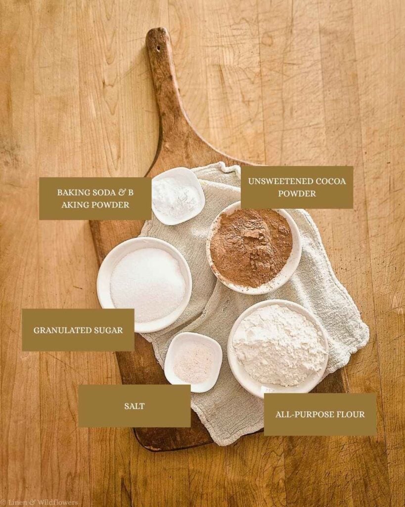 Ingredients for homemade chocolate cake mix: flour, sugar, cocoa powder, baking soda, baking powder, and salt.