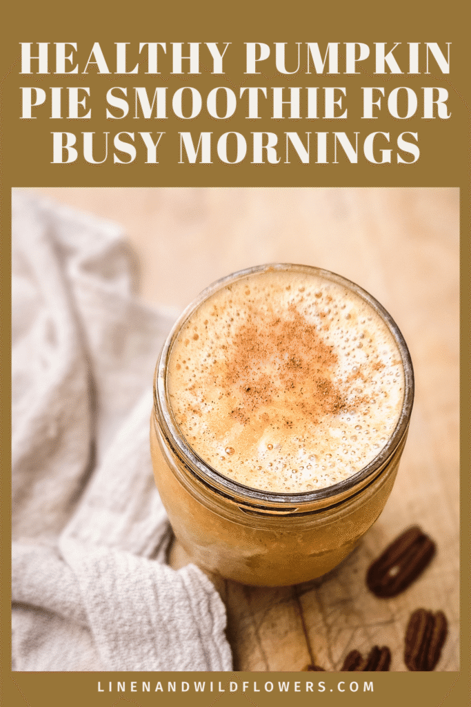 Overhead view of a healthy pumpkin pie smoothie for busy mornings, a frothy cinnamon-dusted fall breakfast in a mason jar with pecans and a linen towel